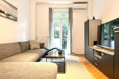 a living room with a couch and a tv at Lang's square apartment in Zagreb