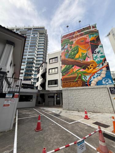 a mural on the side of a building with orange cones at ISA Hotel Amber Road in Singapore