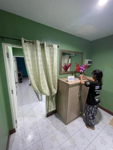 a woman standing at a counter in a room at Ciao Bella GuestHouse & Bistro in Kata Beach