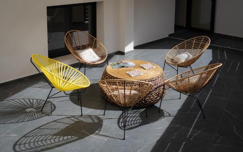 a group of chairs and a table in a room at Rea Boutique Apartments in Agia Galini