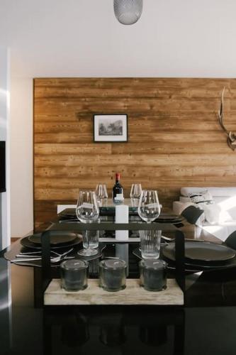- une table avec des verres à vin et des assiettes dans l'établissement Le Repaire 830 - Appartement 6 personnes - Saint Lary Soulan, à Saint-Lary-Soulan