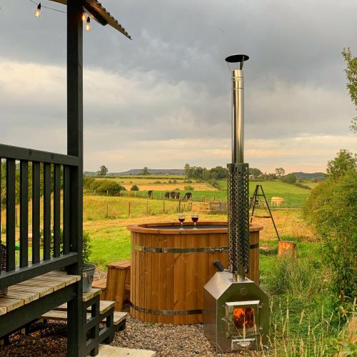 a wood fired hot tub and a wood fired stove at Westfield House Farm in Rothbury