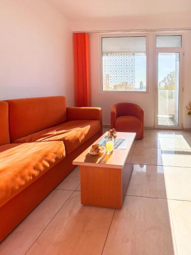 a living room with a couch and a coffee table at HOTEL DUNĂREA in Mamaia
