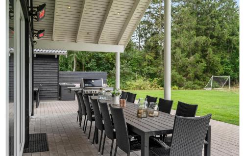 a wooden table and chairs on a patio at Holiday Home Frederiksværk With Fireplace 03 in Frederiksværk