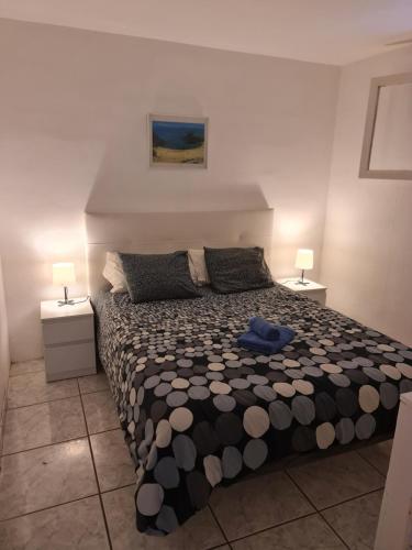 a bedroom with a large bed with two night stands at Casa Eowyn in Puerto del Carmen