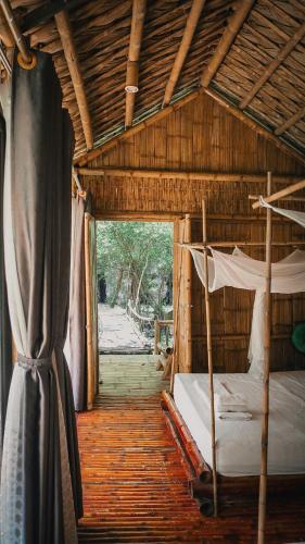a bedroom with two bunk beds in a wooden house at Chez Beo Homestay in Ninh Binh