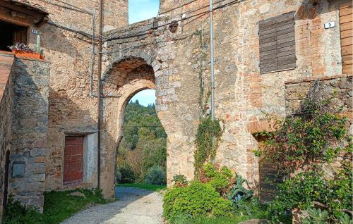 an old brick building with an archway in it at Awesome Apartment In Monticiano in Monticiano