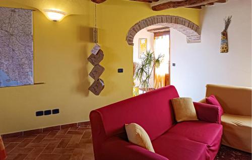 a living room with a red couch and a window at Awesome Apartment In Monticiano in Monticiano