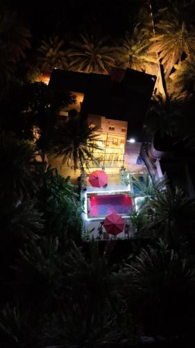 an overhead view of a building with umbrellas at night at Riad Nizwa in Nizwa
