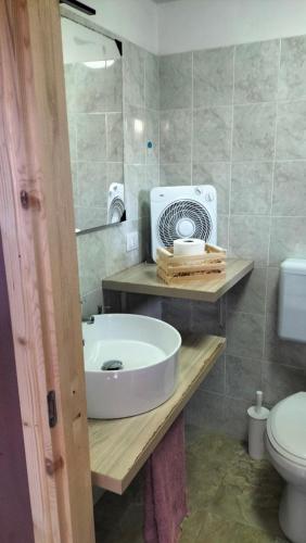 a bathroom with a sink and a fan on a counter at Gi&Sa in Gallipoli