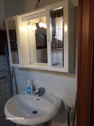 a bathroom sink with a medicine cabinet and a mirror at La corte dei celti -1 in San Benedetto Del Querceto
