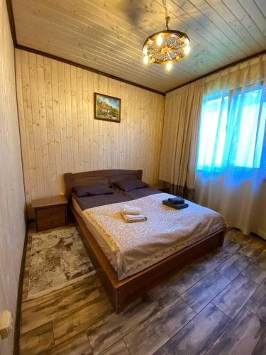a bedroom with a large bed in a room at Five House in Skhidnitsa