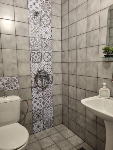 a bathroom with a toilet and a sink at Dezudava Family Hotel in Sandanski