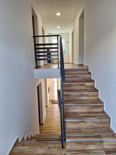 a staircase in a house with wood flooring at BUBO Penzion & Restaurant in Moravany