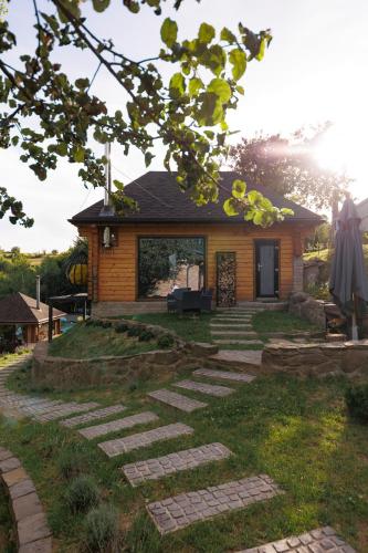 a house with a stone path in front of it at Vdoma Karpaty in Vilshynki
