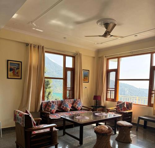 a living room with a couch and a table at Villa Vikas Studio in Dharamshala