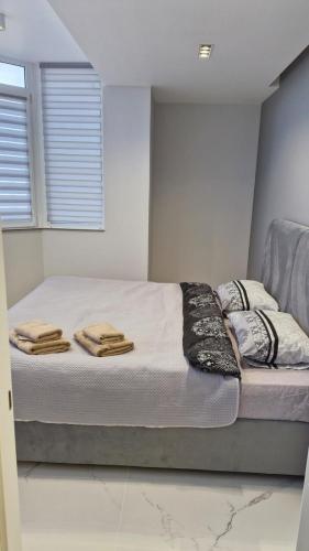 a bedroom with a bed with towels on it at Air-Moldova Dacia in Chişinău