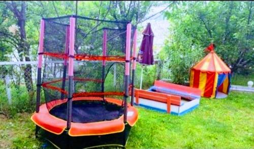 a playground with a play set in the grass at Guest House Sofia in Sandanski