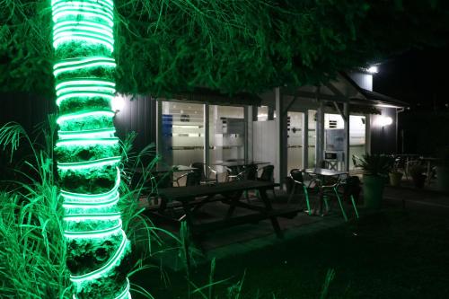 a green lighted column in front of a building at Fasthotel Albertville in Albertville