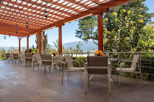 a row of chairs and tables on a patio at San Jose de Puembo Quito Airport, an Ascend Collection Hotel in Puembo