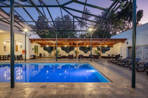 a pool with a pergola and a swimming pool at San Jose de Puembo Quito Airport, an Ascend Collection Hotel in Puembo