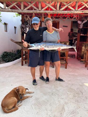 a man and a woman holding a fish on a tray at The View of Zanzibar in Michamvi