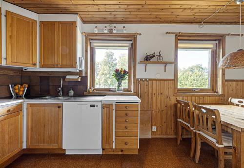a kitchen with a table and a white refrigerator at Dream location with lake view & Top location near in Bro