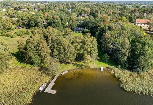 an aerial view of a lake with a group of trees at Dream location with lake view & Top location near in Bro