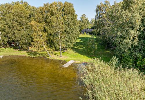 a river with a wooden dock in the middle of it at Dream location with lake view & Top location near in Bro