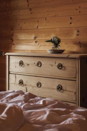 a wooden dresser with a flower on top of it at Alpen-Chalet-Pankraz in Fügenberg