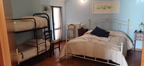 a bedroom with two bunk beds and a window at Al Vecchio Camino in Rotonda