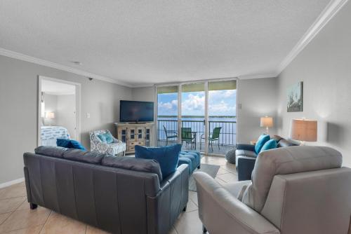a living room with a couch and chairs and a television at Tristan Towers unit 14D in Pensacola Beach