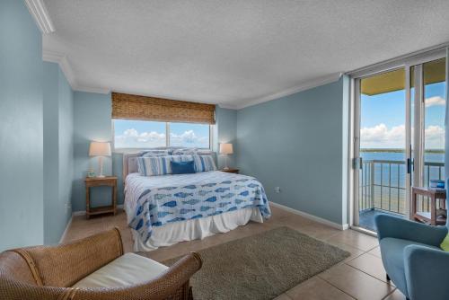 a bedroom with a bed with a view of the ocean at Tristan Towers unit 14D in Pensacola Beach