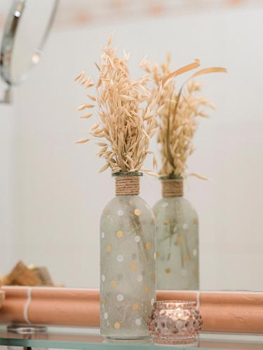 two vases with plants in them sitting on a table at Apparthotel "Landhaus Veronika" in Mayrhofen