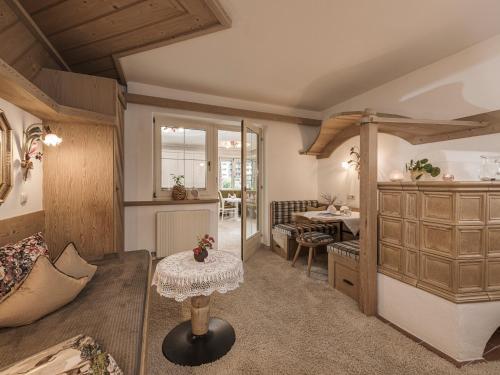 a living room with a table in a room at Apparthotel "Landhaus Veronika" in Mayrhofen
