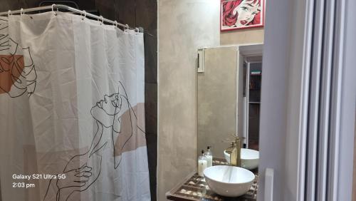 a bathroom with a shower curtain and a sink at The Coolest Place near the airport! in Lisbon