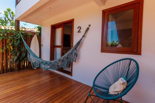a hammock on the porch of a house at Villa Estrela Bungalow in Itacaré