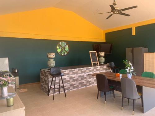 a dining room with a table and chairs at Pajaree and Udo‘s Happy Homestay in Trang