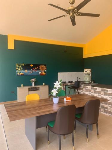 a dining room with a wooden table and chairs at Pajaree and Udo‘s Happy Homestay in Trang