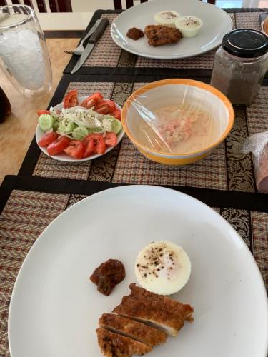a table with three plates of food on it at Pajaree and Udo‘s Happy Homestay in Trang