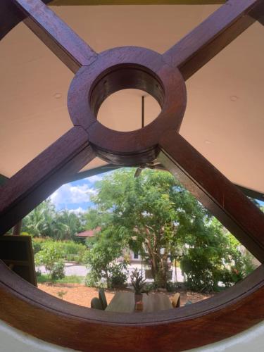 a circular window with a tree in the background at Pajaree and Udo‘s Happy Homestay in Trang