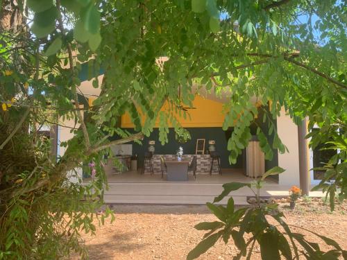 a building with a patio with a table and chairs at Pajaree and Udo‘s Happy Homestay in Trang