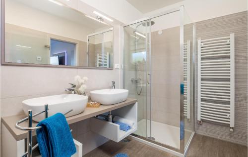 a bathroom with a sink and a shower at Cozy Home In Punat With Sauna in Punat