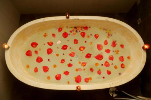 a pan full of food with toppings on it at Old Kent Estates & Spa, Coorg in Suntikoppa