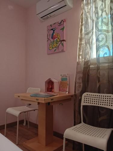 a desk with two chairs and a table with a laptop on it at Katia 's Country House in Sikión