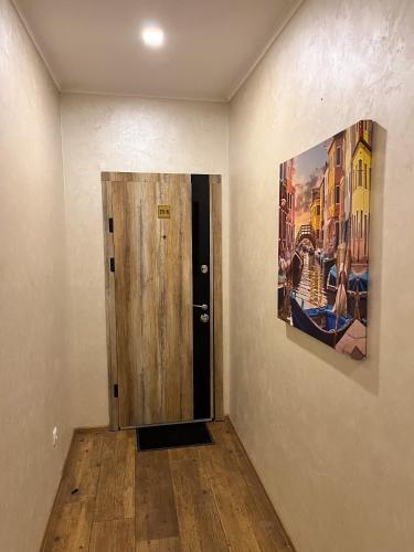 a painting hanging on a wall next to a door at Апарт-отель "ГАЛАГОВЪ" in Uzhhorod