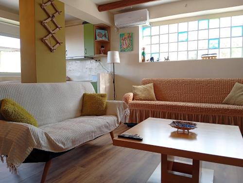 a living room with two couches and a coffee table at Katia 's Country House in Sikión