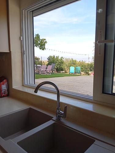 a kitchen sink in front of a window at Katia 's Country House in Sikión