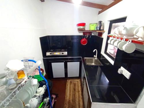 a small kitchen with a sink and a counter top at Ramesh Guesthouse in Mirissa