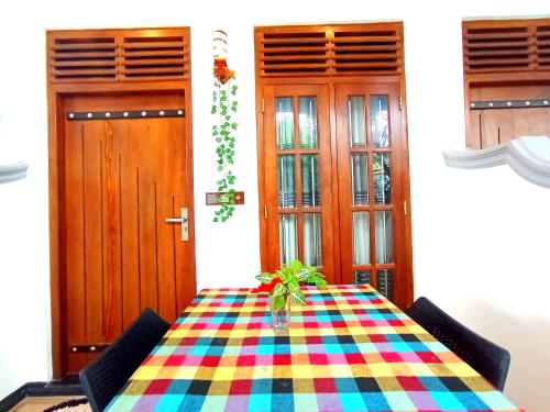 a table with a colorful table cloth in a room at Ramesh Guesthouse in Mirissa